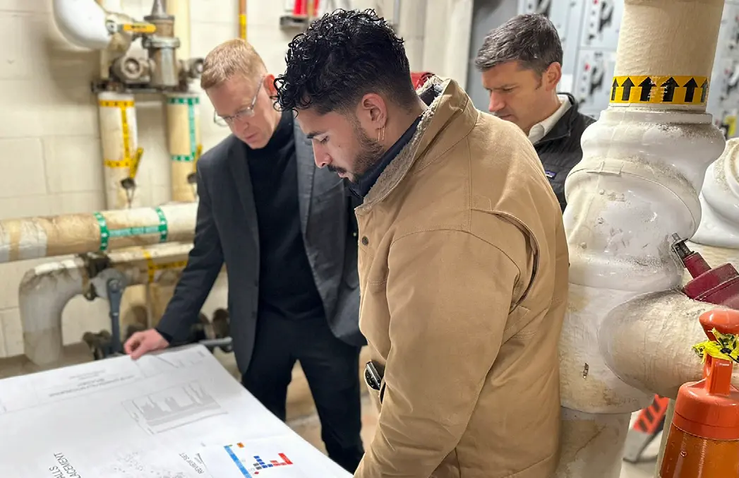 Leopardo team members reviewing HVAC replacement plans